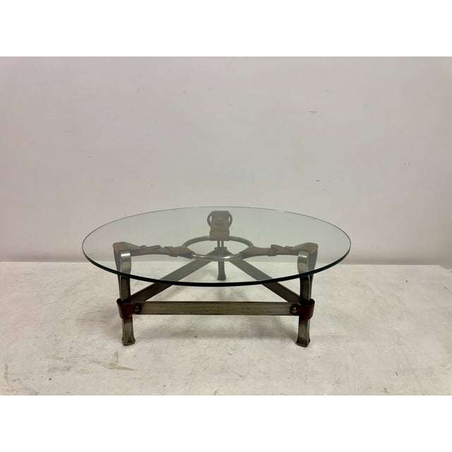 A striking postmodern coffee table in the manner of Jacques Adnet, designed by Jean-Pierre Ryckaert, combining industrial...