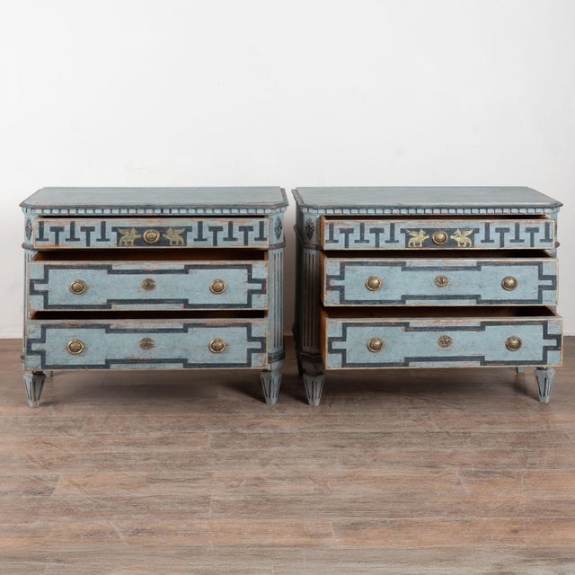 A pair of elegant Gustavian chest of drawers painted in shades of blue, fitting their Swedish origin. Note the decorative...