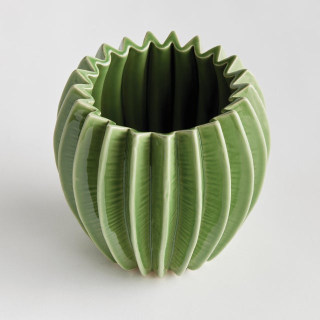 With a rounded form, deep ribbing and thickly applied glaze, this natureinspired pot is a work of art. The handfinished...