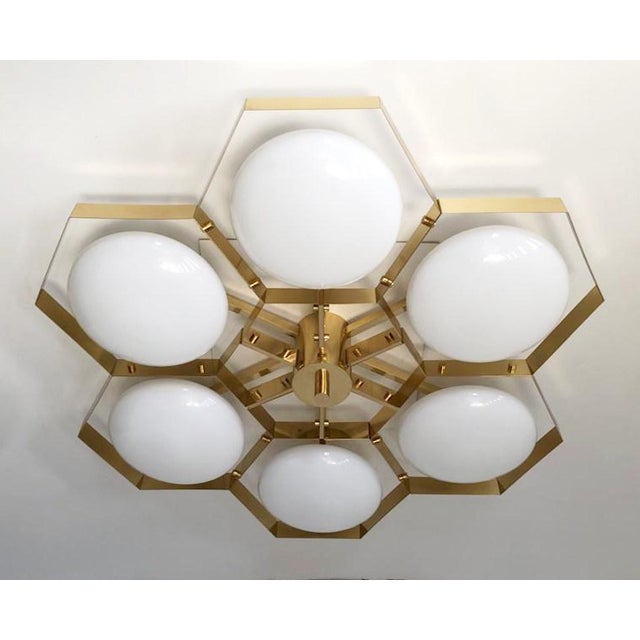 Italian midcentury flush mount with six glossy white Murano glass shades mounted on solid brass frame in lacquered...