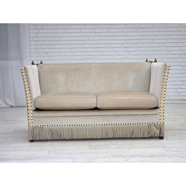 1970s, Danish 2-seater drop arm "Spanish" sofa. Original light beige furniture velour, beech wood legs, springs in the...