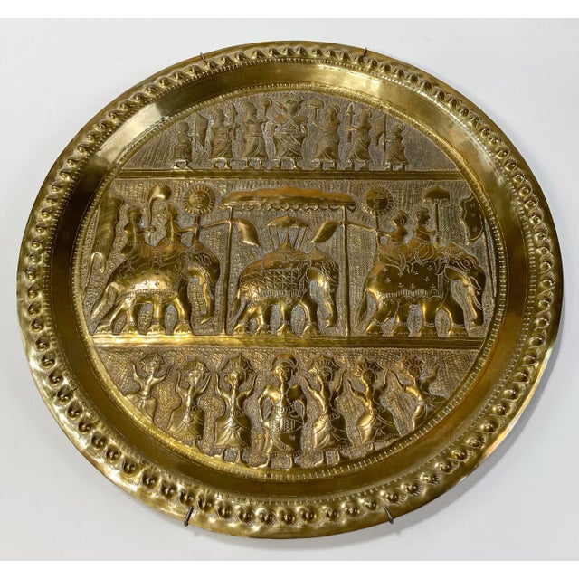 Round brass tray featuring an Egyptian design adorned with dancers and elephant caravan. Wonderful detail with a deep...