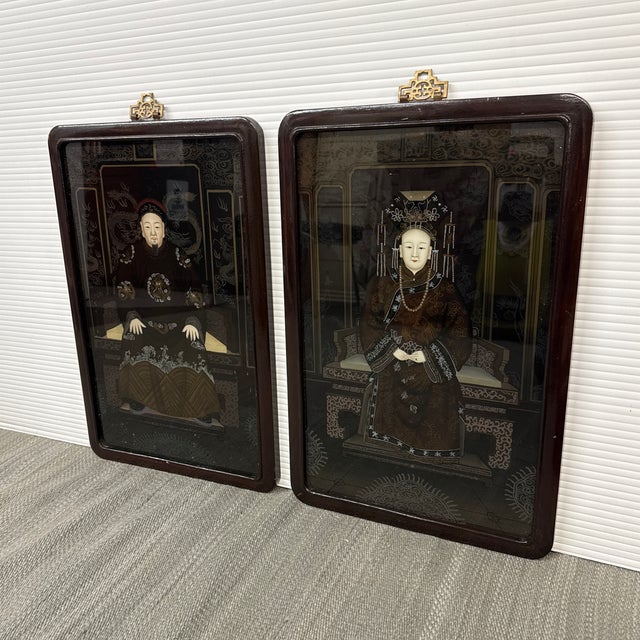 Design Plus Gallery presents a Set of Two Reverse Glass Paintings. The images displays a pair of antique Chinese reverse...