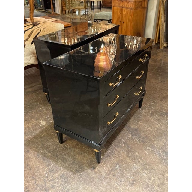 This product is a pair of black lacquered Louis XVI bedside tables, adding a touch of elegance and sophistication to any...