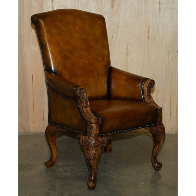 An exceptionally grand and imposing pair of fully restored antique throne-style armchairs. Featuring heavily hand-carved...