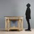 Neoclassical-style console table, carved and lacquered. Black marble top, supported by truncated pyramidal legs with...