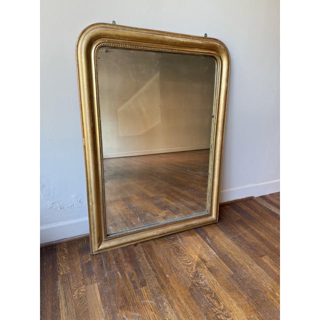 A 19th Century French Louis Philippe mirror, richly gilded and framed with the period’s signature understated curves. It's...