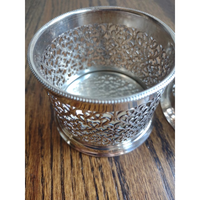 Offered are a set of 2 vintage Italian silver-plated bottle coasters. They are very pretty with reticulated sides and a...