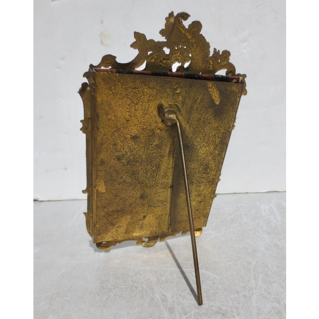 Gilt Photo Frame with slide-in glass panel. The back brace is a single-hinge rod. Rococo design circa 1910. The...