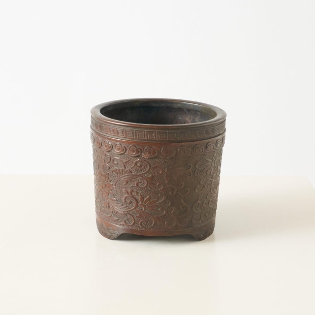 Bronze Censer with Lotus Carvings Decorative bronze censer with intricate lotus-shaped carvings and a geometric meander...