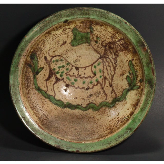 An amazing wheel thrown earthenware / redware bowl Grey glazed interior with primitively painted by hand brown bull in the...