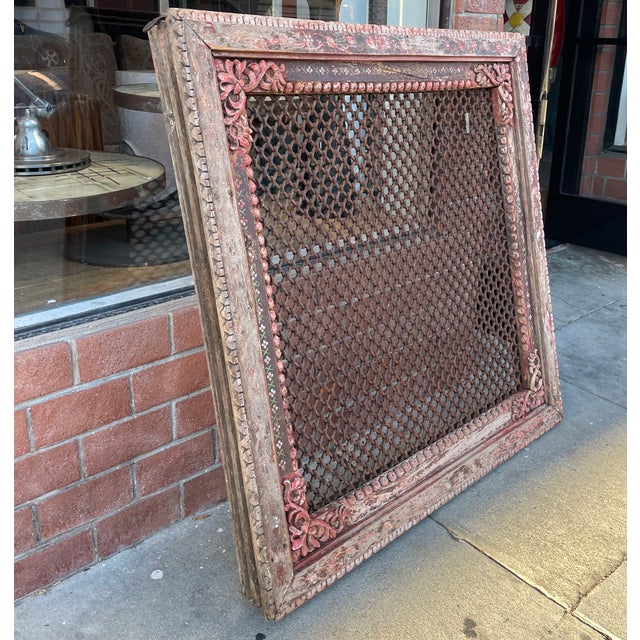 This antique architectural window frame features hand-carved floral corners, a vibrant distressed green patina, and an...