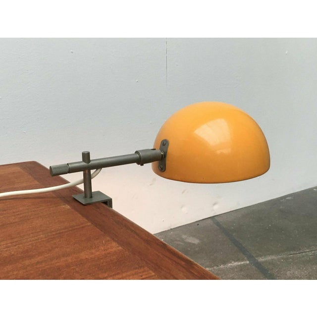 Mid-century clamp lamp from Beisl with a yellow shade. The simple dome shape of the umbrella is striking. In addition, it...
