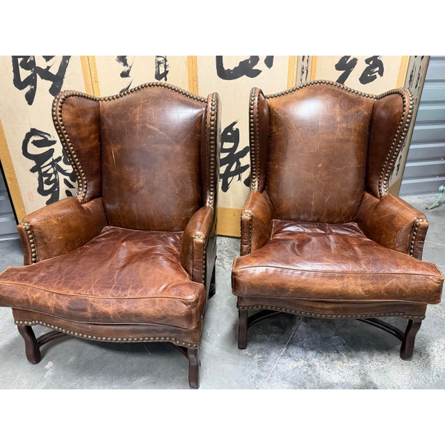 Amazing matching pair of vintage Barclay-Butera brown leather wingback chairs with with hand-applied nailhead trim, in...