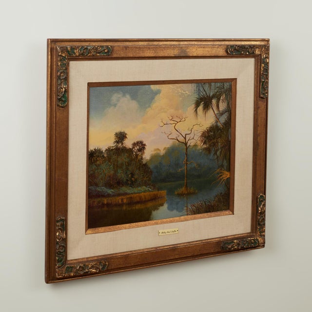 Transporting oil painting on canvas of tropical landscape with trees and water under a sky with clouds capturing Florida's...