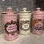 Each jar has a classic cylindrical silhouette, complete with a stepped base, a distinct collar neck, and a matching fitted...