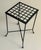 A wrought iron side table with latticework top. Painted a hammered silver finish.