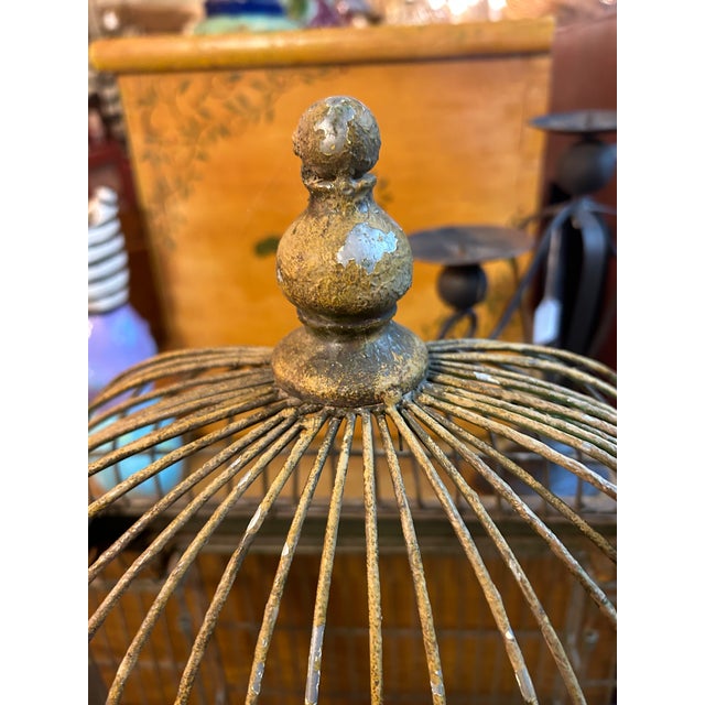 Magical extremely large vintage metal bird cage having a bump out at the back. Distressed condition, but functional. 13.25...
