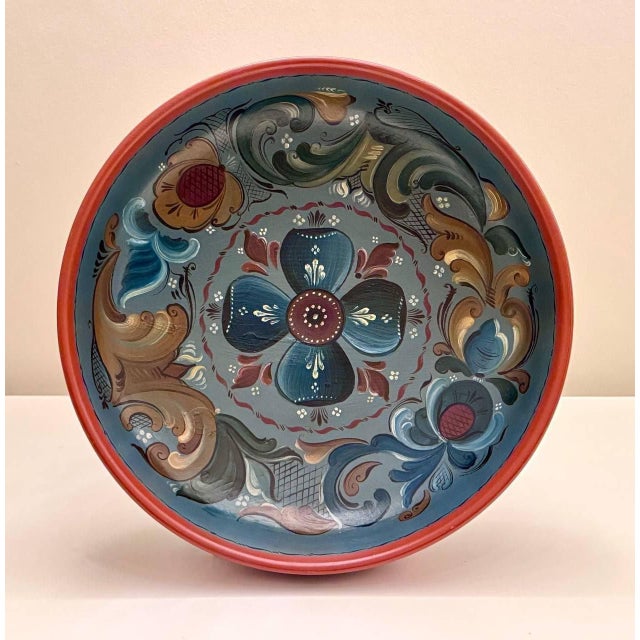 A large vintage Norwegian hand-painted wooden bowl, decorated in a rosemaling-inspired folk-art style and dating to the...