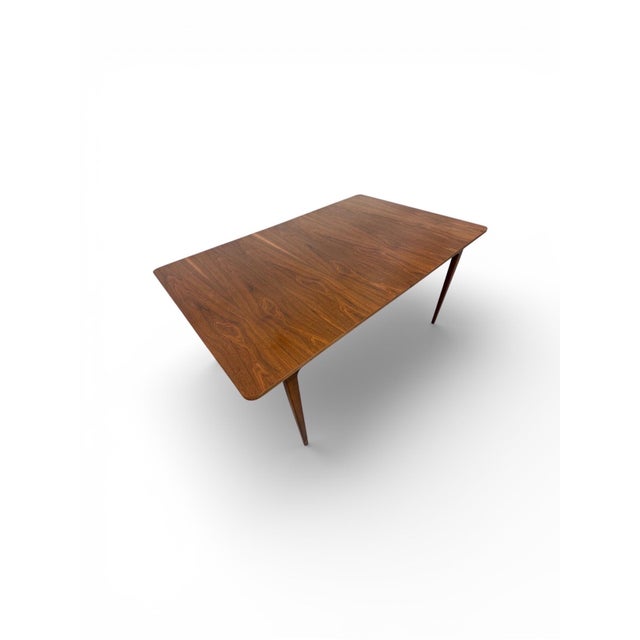 Elevate your dining space with this stunning Mid-Century Modern walnut dining table by Young Manufacturing, a perfect...
