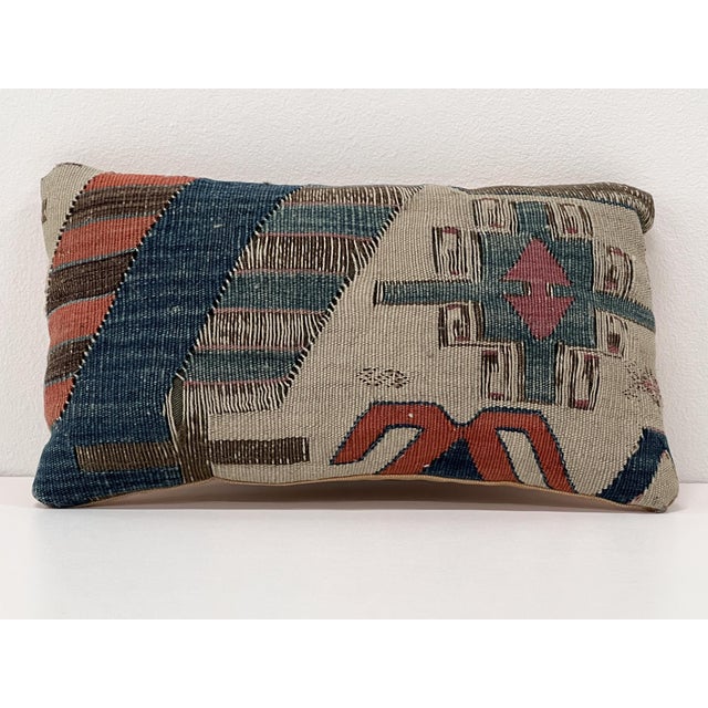 Handcrafted accent pillow made from a vintage handwoven Turkish kilim, featuring deep indigo, charcoal, ivory, chocolate...