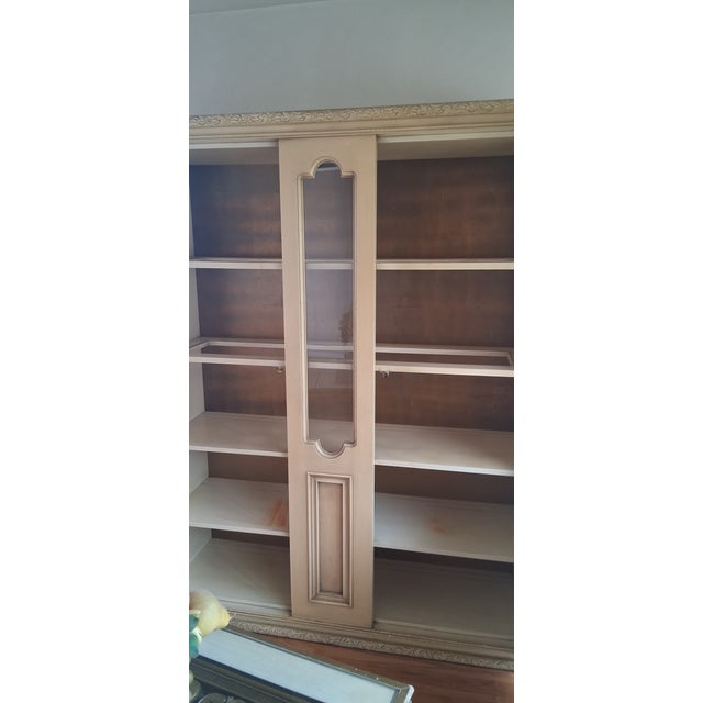 This striking vintage cabinet, dating back to 1961, features a beautiful contrast between its painted cream finish and...