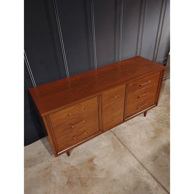 This is a nine drawer lowboy dresser made by the Huntley Furniture Co. It’s been restored and refinished. It is walnut...