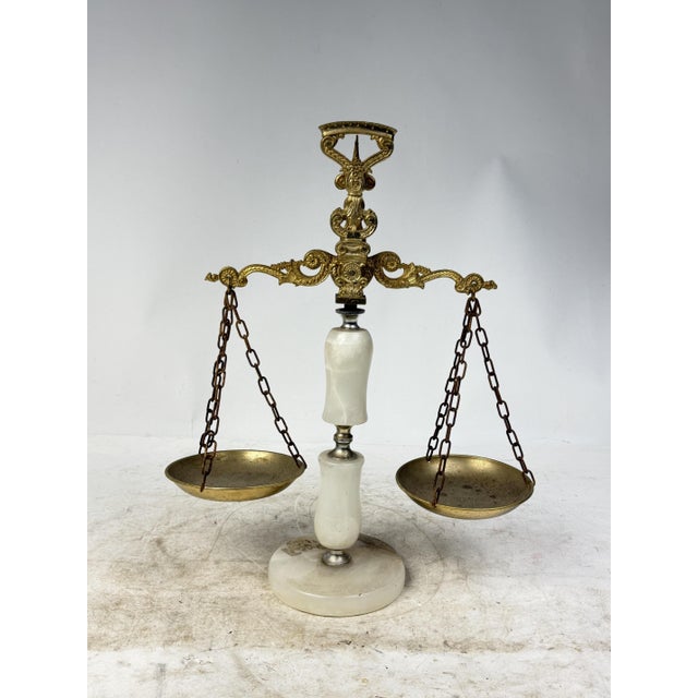 Beautiful antique plate scale in wrought brass and onyx. A piece of history that adds charm and character to your decor....