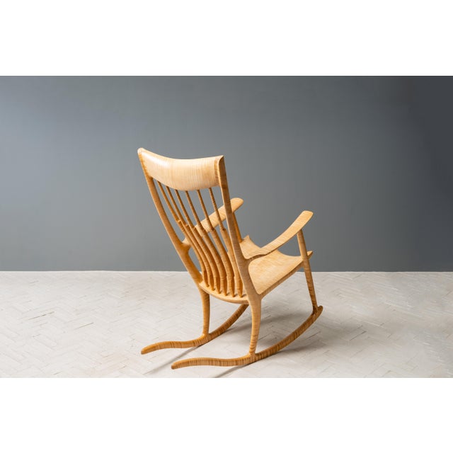 USA, ca. 2000s. A stunning and sculptural rocking chair after American woodworker and studio furniture maker Sam Maloof...