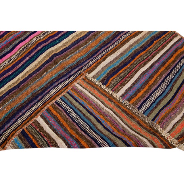 Beautiful kilim handmade wool runner with a multicolor field. This Vintage flatweave rug features a gorgeous all-over...