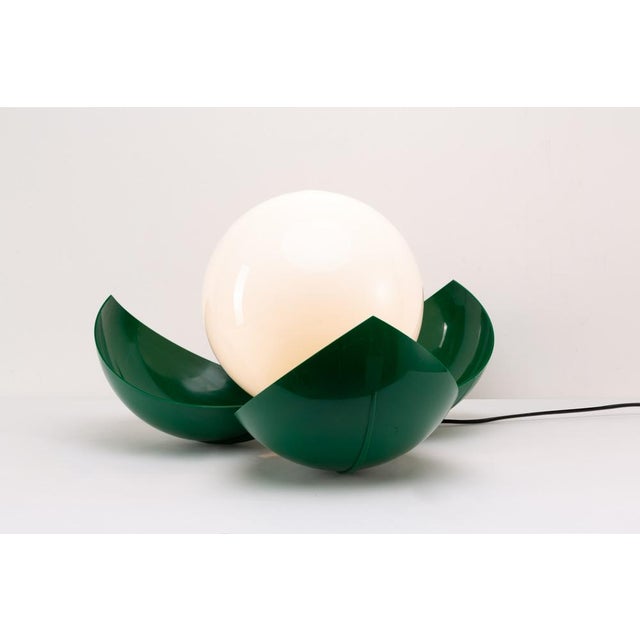 Table lamp with electrically controlled opening and closing, hard plastic structure. Production Artemide Period 1970...