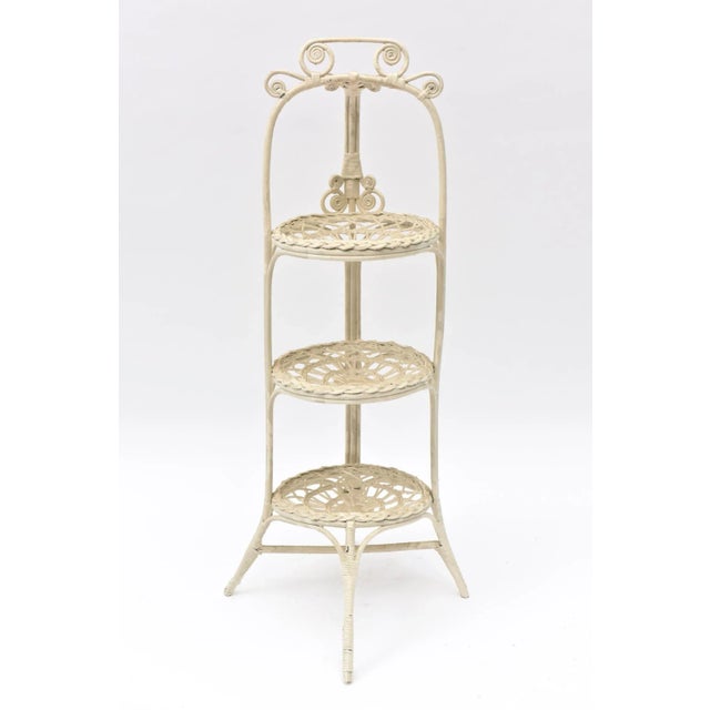 The ornate muffin stand has splay feet and 3 tiers made to hold 3 cake or muffin plates. The base and top of the handle...