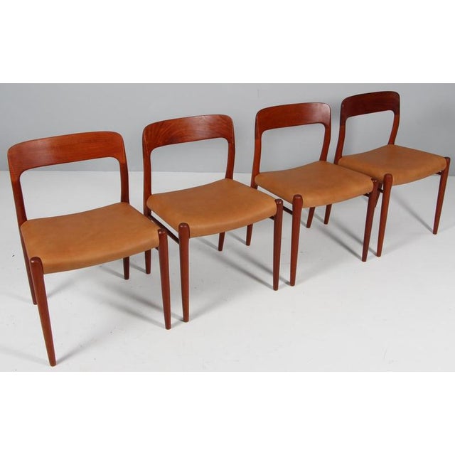 Set of four n. O. Møller dining chairs with frame of solid teak. Seats new upholstered with tan aniline leather model 75,...