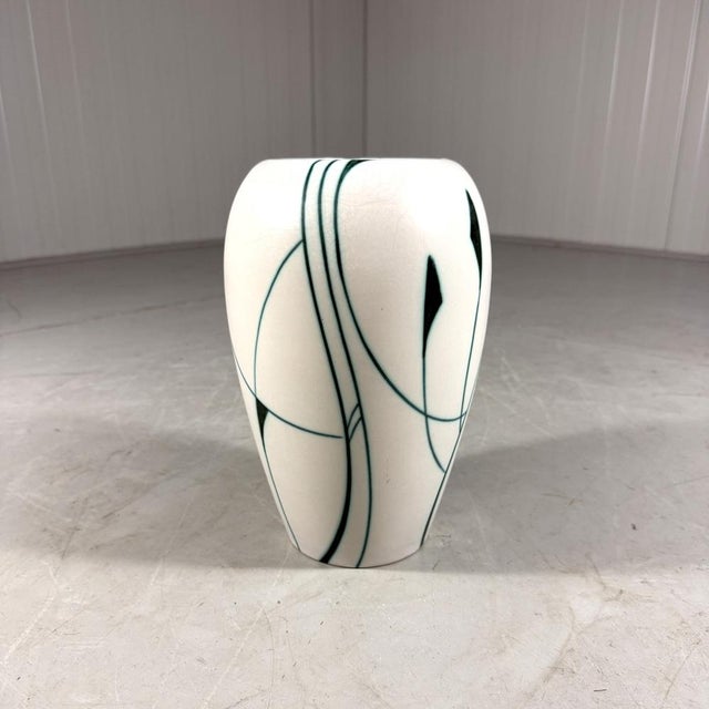 Stylish vase Liane by Flora Gouda, Netherlands (signed). White ceramic with green lianas decoration. 1960’s. In very good...