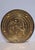 A pair of round brass repoussé wall plaques, each hand-worked in relief depicting a different courtship scene with figures...