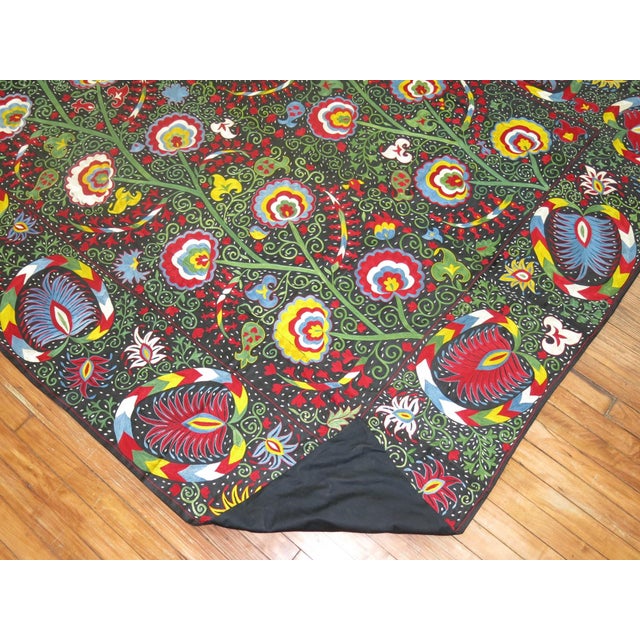 Hand-embroidered Suzani textile made in the last quarter of the 20th century. Glowing vibrant colors executed by the weave...