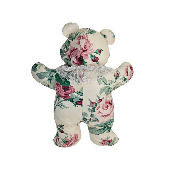 This vintage stuffed animal toy features a bear with a floral design. It is made from cotton and comes in a color palette...