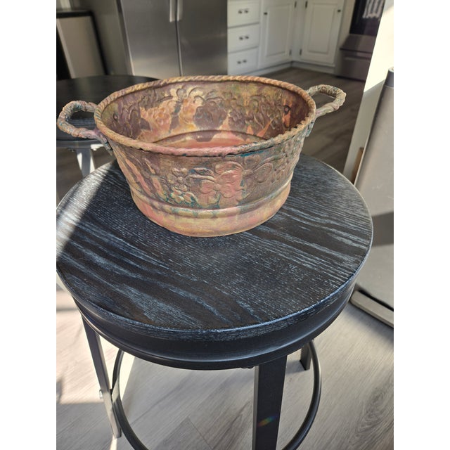 19th-century antique copper and brass alloy decorative planter/jardinière cachepot. This piece features detailed repoussé...