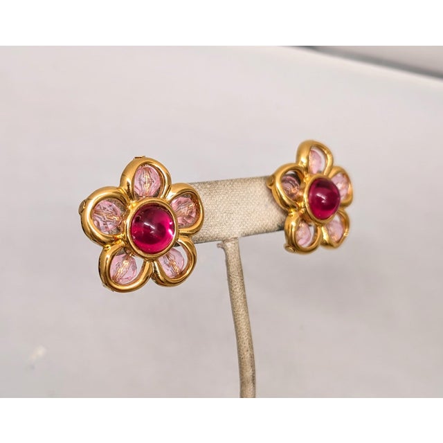 Goldtone pink rhinestone cabochon center with pink faceted beads flower pierced push back earrings. Marked "NAPIER©" on...