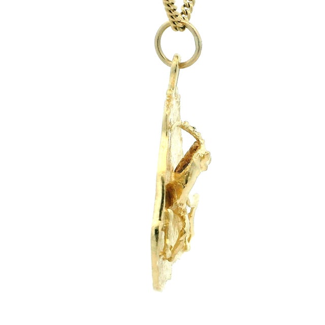 A distinctive handcrafted Italian 14K yellow gold pendant dating to the 1970s, featuring a beautifully sculpted ram...