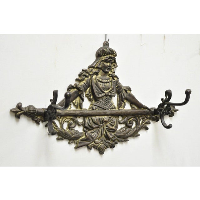 Vintage Victorian Style Cast Iron Figural Maiden Wall Coat Hat Hook. Circa Mid 20th Century. Measurements: 11.5" H x 18" W...