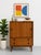 Vintage Mid Century Modern Danish teak cabinet featuring beautifully sculpted recessed pulls, clean architectural lines,...