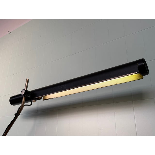 This is a vintage tubular desk lamp dating back to the 1970s. The design is typical of industrial and office lighting of...
