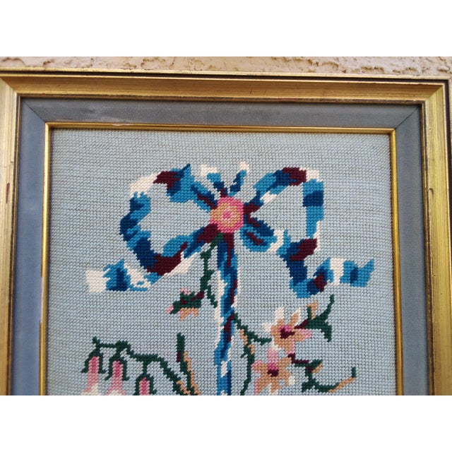 Lovely professionally framed floral needlepoint features pink roses, other small flowers, and a bow on a light blue...