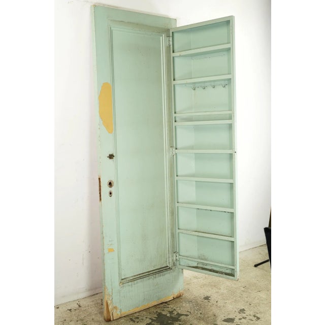 Very unique passage door with one side painted red and a textured wallpaper single panel, and the other side painted green...