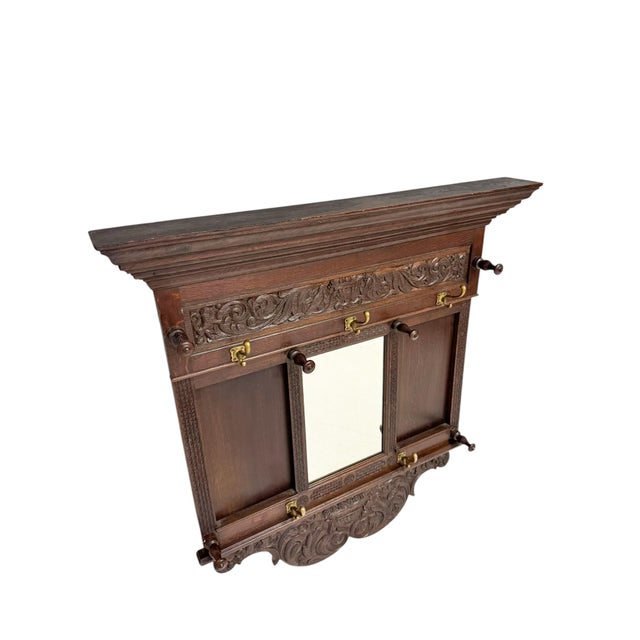 Stunning and elegant Renaissance Revival coat rack. Striking Dutch design from the 1900s. Hand-carved solid oak frame with...
