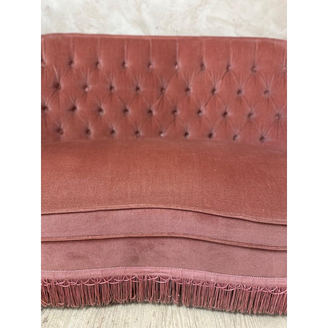 Charming 1950s tub sofa, fully upholstered in elegant powder pink velvet, offering a generous and inviting silhouette. Its...