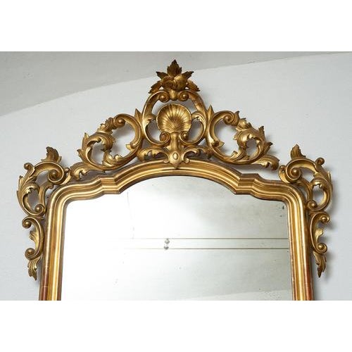 Neapolitan Louis Philippe mirror from the first half of the 19th century, entirely carved, engraved, and gilded with gold...