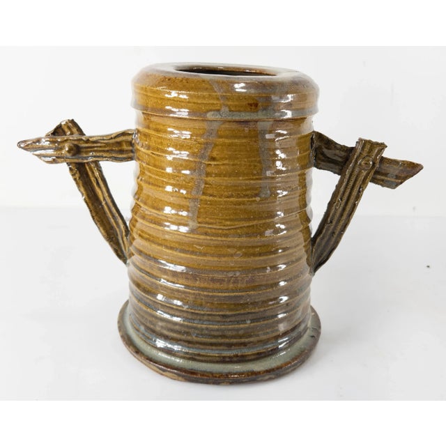 We are selling this cool contemporary Art pottery vase. This alkaline vase has unique shape with handles and is signed on...