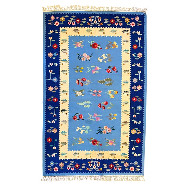 This is a mid-20th-century Romanian Oltenian handwoven wool kilim, featuring the distinctive folkloric floral imagery...
